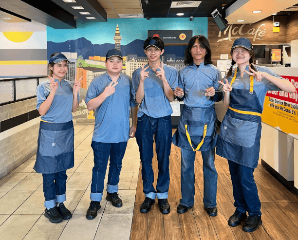 Fast Food Restaurant Team Smiling In Uniform