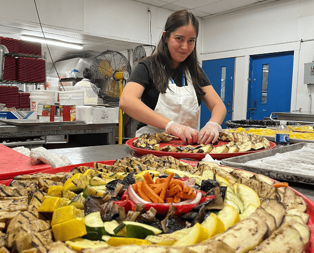 Female Chef Arranging Colorful Vegetable Platter