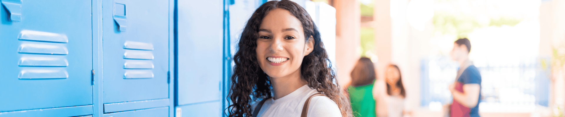Female Student At Locker In School Hall