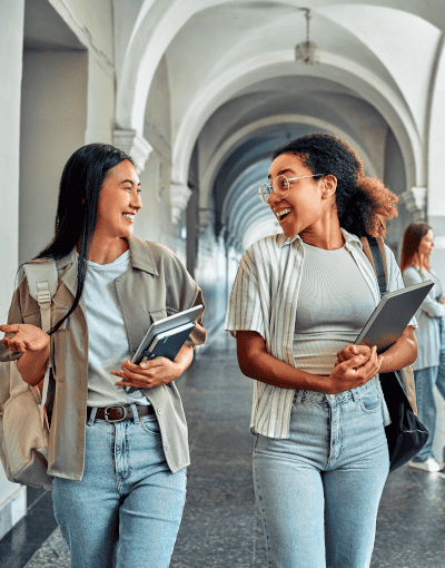 Female Students Talking In University Hallway