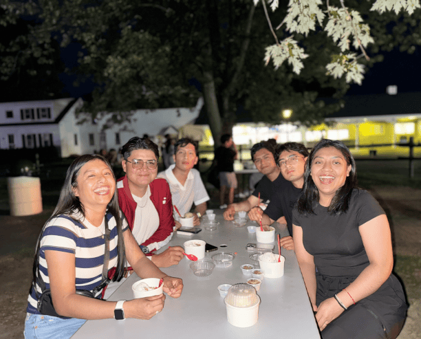 Friends Enjoying Dessert Together Outside At Night