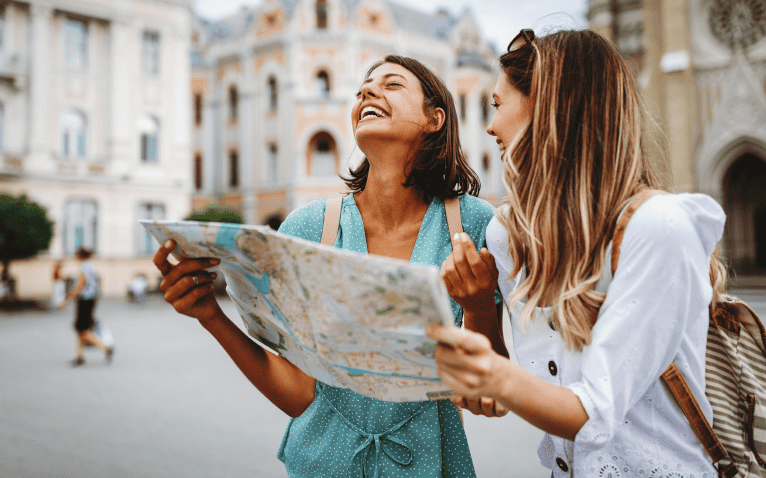 Friends Laughing While Navigating With Map