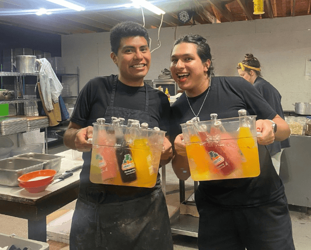 Kitchen Staff Holding Colorful Jarritos Drinks
