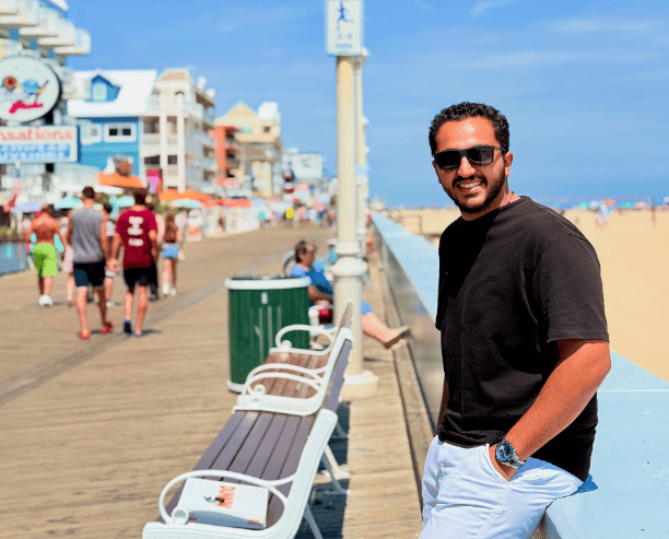 Man Relaxing On Beach Boardwalk