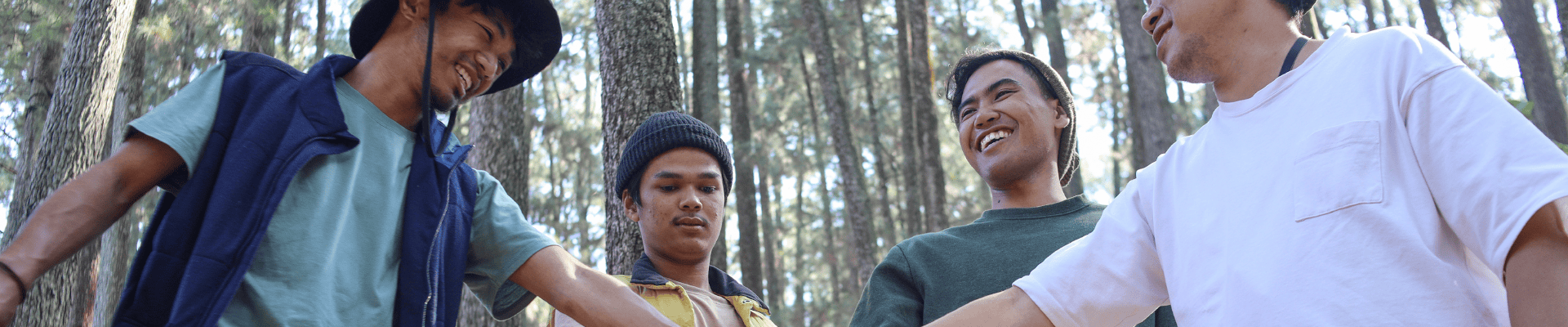 Men In Forest Doing Team Building Activity