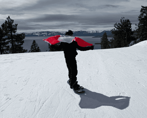 Snowboarder Holding Mexican Flag On Slope