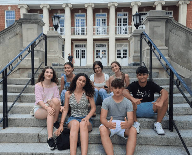 Students Sitting On University Campus Steps