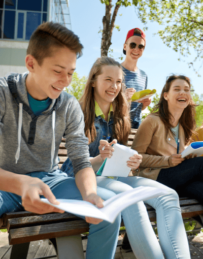 Teenage Students Laughing Studying Outdoors