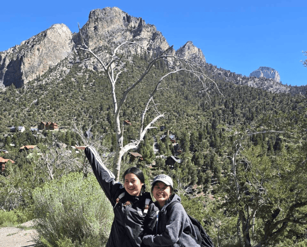 Two Women Hiking In Mountain Forest