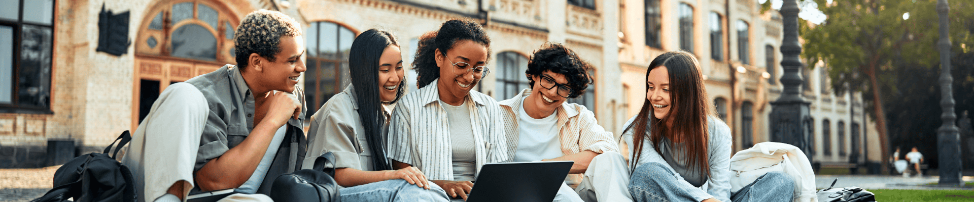 University Students Studying On Campus Lawn