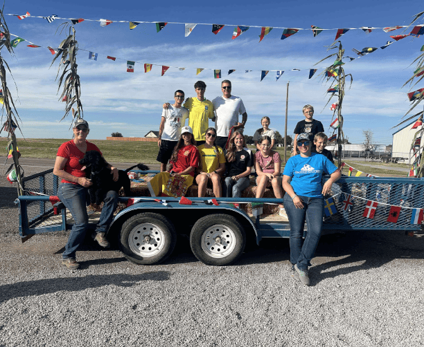 Group On Festive Parade Trailer With Flags