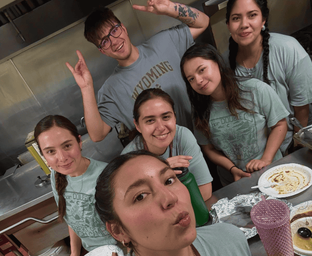 Kitchen Team Smiling And Posing Together