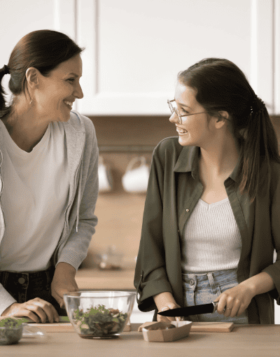Mother And Daughter Preparing Meal Together