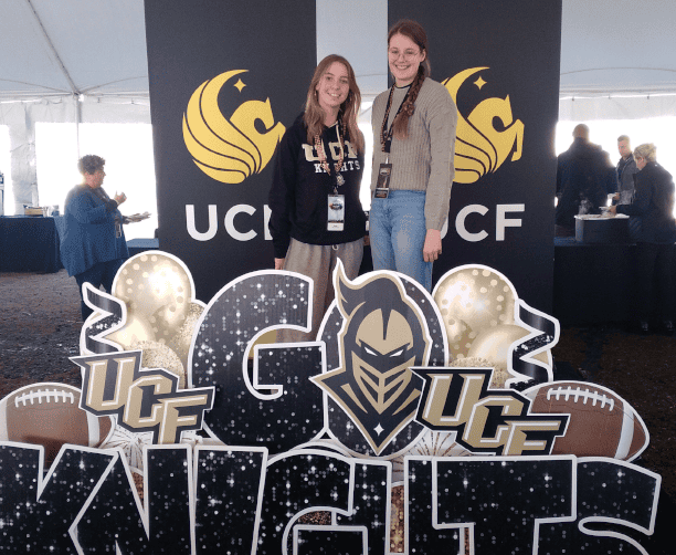 Students Posing At Ucf Knights Event Booth